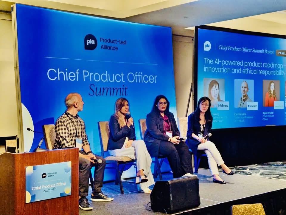 Dipali Trivedi on stage with three fellow panelists at the Product-Led Alliance Chief Product Officer Summit in Boston, beside a screen titled The AI-powered product roadmap — innovation and ethical responsibility