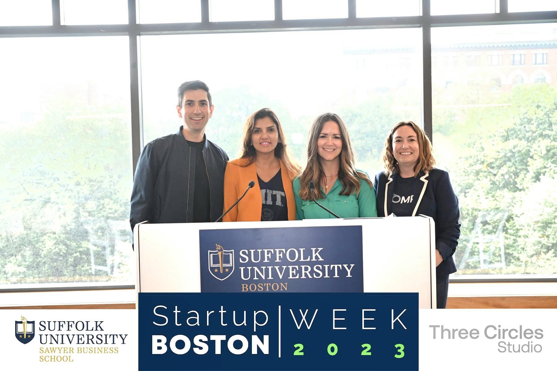 Dipali Trivedi at the podium with three fellow panelists at Startup Boston Week 2023, Suffolk University Sawyer Business School